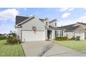 Two-story gray house with white garage doors and well-maintained lawn at 2626 Yellow Pine Rd, Raleigh, NC 27616