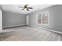 Bright bedroom with gray walls, wood-look floors, and large window at 2862 Filbert St, Raleigh, NC 27610
