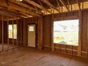 Interior framing of a room under construction, featuring a door and large window at 30 Seahawk Way, Zebulon, NC 27597