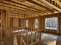 Interior framing of a room under construction, showing large windows at 30 Seahawk Way, Zebulon, NC 27597