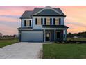 Stunning two-story home with gray siding, white trim, and a welcoming front porch at 339 Suhani Ln, Clayton, NC 27520