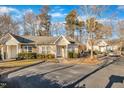 Attractive single-story residence featuring beige siding, white windows, and lush landscaping for added curb appeal at 3727 Votive Ln, Raleigh, NC 27604