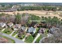 Beautiful aerial view of homes on 7329 Dunsany Drive with golf course and clubhouse in the distance at 7320 Dunsany Ct, Wake Forest, NC 27587