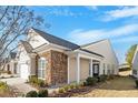 House exterior showcasing stone and beige siding with a covered porch at 755 Finnbar Dr, Cary, NC 27519