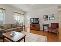 Spacious living room with hardwood floors and a view of the kitchen at 755 Finnbar Dr, Cary, NC 27519