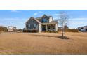 Charming two-story home with well-kept landscaping and a young sapling in the front yard at 8217 Cannon Grove Dr, Willow Springs, NC 27592