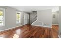 Hardwood floor living room with neutral walls and a staircase at 101 Stefi Ct, Garner, NC 27529