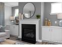 Living room featuring a modern fireplace and built-in shelving at 1051 Cross Rail Ln, Raleigh, NC 27603