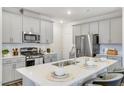Modern kitchen with gray cabinets, quartz countertops, and stainless steel appliances at 1139 Atterlee Ln, Graham, NC 27253