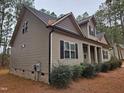 Side view of the house showcasing vinyl siding and landscaping at 117 Majestic Dr, Princeton, NC 27569
