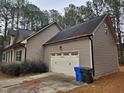 Two-car garage with driveway and landscaping at 117 Majestic Dr, Princeton, NC 27569