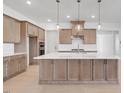Bright kitchen features a large island with pendant lighting and stainless steel appliances at 200 Regency Ridge Dr, Holly Springs, NC 27540