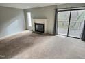 Living room with fireplace, carpet, and access to a deck at 250 S Estes Dr # Apt 94, Chapel Hill, NC 27514