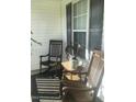 Cozy front porch with rocking chairs and small table at 288 Rosa Cir, Willow Springs, NC 27592