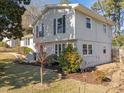 Side view of a light-grey two story house with landscaping at 317 Compton Rd, Raleigh, NC 27609
