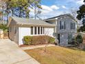 Rear view of a two-story house with gray siding and a driveway at 317 Compton Rd, Raleigh, NC 27609