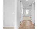 Bright hallway with wood-look flooring and carpeted stairs at 41 Alderman Ct, Dunn, NC 28334