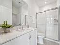 Sparkling clean bathroom with glass shower, white vanity and modern fixtures at 524 Billingshurst Way, Knightdale, NC 27545