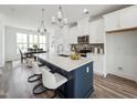 Bright modern kitchen with white cabinets, large island, and stainless steel appliances at 524 Billingshurst Way, Knightdale, NC 27545
