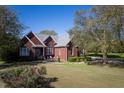 Brick house with a large yard and mature trees at 555 House Rd, Kenly, NC 27542