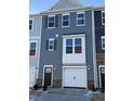 New townhome featuring stone accents, an attached garage, neutral siding, and shuttered windows at 851 Parc Townes Dr # 10, Wendell, NC 27591