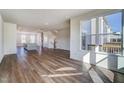 A light-filled, open-concept living space with hardwood floors and a view of the kitchen and deck at 851 Parc Townes Dr # 10, Wendell, NC 27591