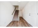 Hallway view of wood floors with stairs and doors leading to other rooms at 865 Parc Townes Dr # 4, Wendell, NC 27591