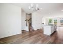 Bright, open-concept living area flows into a modern kitchen with granite countertops and wood flooring at 865 Parc Townes Dr # 4, Wendell, NC 27591
