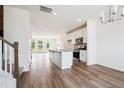 An open-concept living area flows into a modern kitchen, stairs, and out to the deck at 865 Parc Townes Dr # 4, Wendell, NC 27591
