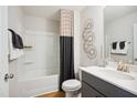 Modern bathroom with shower/tub combo, vanity, and dark gray cabinetry at 871 Parc Townes Dr # 1, Wendell, NC 27591