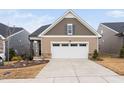 Charming single-Gathering home featuring a two-car garage and manicured front yard at 1008 Ashton Oak Ct, Durham, NC 27703
