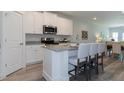 Modern kitchen with granite countertops, stainless steel appliances, and an island at 1741 Old Fields Blvd, Haw River, NC 27258