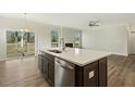 Kitchen island with white countertop, stainless steel dishwasher, and sink at 181 Sage Ln, Four Oaks, NC 27524