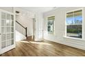 Bright and spacious living room with hardwood floors and large windows at 181 Sage Ln, Four Oaks, NC 27524