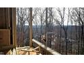 Deck with a view of wooded area and distant homes at 286 W Beech Slope Ct, Chapel Hill, NC 27517
