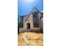 Striking custom home featuring stone accents, an arched entryway, and professional detailing at 286 W Beech Slope Ct, Chapel Hill, NC 27517