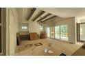 Spacious living room with a fireplace, exposed beams, and sliding doors to the outdoor space at 286 W Beech Slope Ct, Chapel Hill, NC 27517