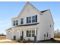 Two-story white farmhouse with black accents, two-car garage, and landscaping at 35 Mable Court # 3, Lillington, NC 27546