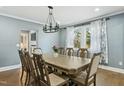 Spacious dining room with a large table, chandelier, and hardwood floors at 507 Hawkins Ave, Sanford, NC 27330