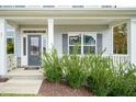 Inviting front porch with gray columns and lush green shrubs at 55 Watermelon Dr, Franklinton, NC 27525