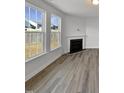 Living room with fireplace and large windows offering natural light at 110 Shining Amber Way, Franklinton, NC 27525