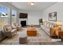 Virtually staged living room with fireplace, neutral decor, and hardwood floors at 110 Shining Amber Way, Franklinton, NC 27525