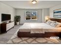 Virtually staged main bedroom with large bed, dresser, and window views at 110 Shining Amber Way, Franklinton, NC 27525