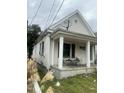 One-story home with porch, showing side yard view at 1103 E Lane St, Raleigh, NC 27601