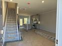 Interior view of a townhome under construction, showing stairs and kitchen at 1235 Willow Tree Way, Graham, NC 27253