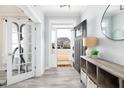 Inviting foyer with light floors and an entry door adjacent to a doorway with a glass door at 147 E Wellesley Dr, Clayton, NC 27520