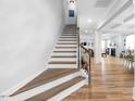 Elegant staircase featuring hardwood stairs and iron railing leading to the upper level at 147 E Wellesley Dr, Clayton, NC 27520
