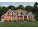 Charming brick home featuring gable accents, well-manicured lawn, and inviting covered porch at 172 Bonica Creek Dr, Garner, NC 27529