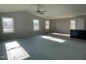 Spacious living room featuring a high ceiling, large windows, and new carpeting at 19 Shiloh Dr, Lillington, NC 27546