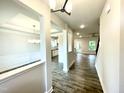 Open-concept entryway with hardwood floors and views of the dining room, kitchen, and staircase at 217 Lake Edge Dr, Lillington, NC 27546